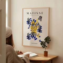Matisse Art Prints -  Abstract Floral Blue Yellow Black Poster displayed on a wall, featuring dynamic floral shapes and colors.