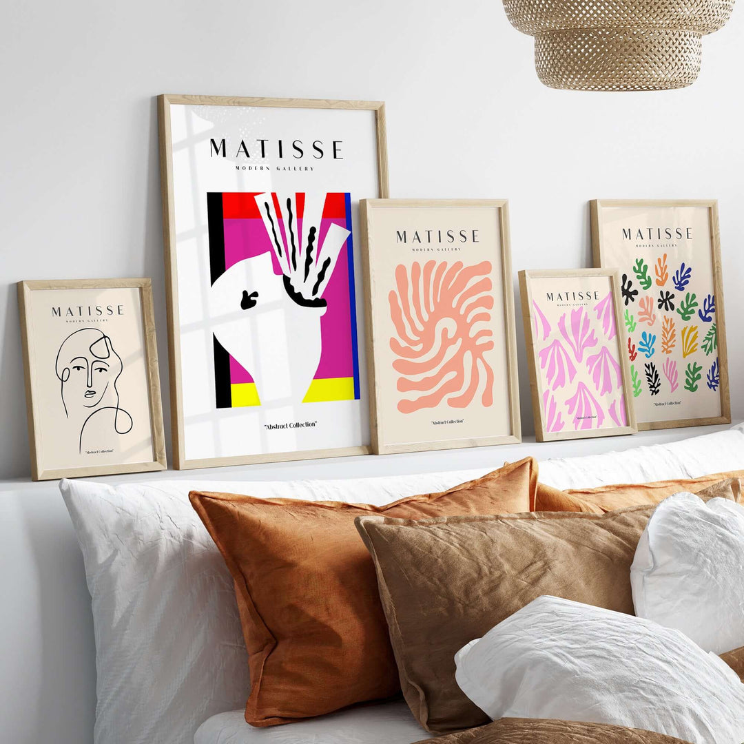 Matisse art prints on a shelf showcasing abstract designs and colors in framed wall art.