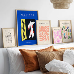 Matisse Art Prints - Icarus Jazz Abstract Art Print Blue displayed among various Matisse art prints on a stylish shelf.
