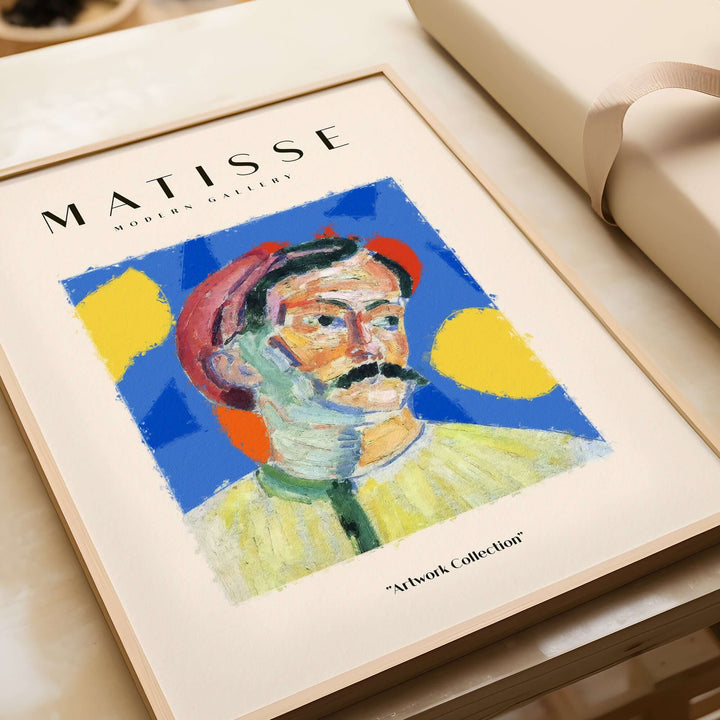 Matisse-inspired abstract portrait print of a man with a mustache and red hat on a vibrant blue background.