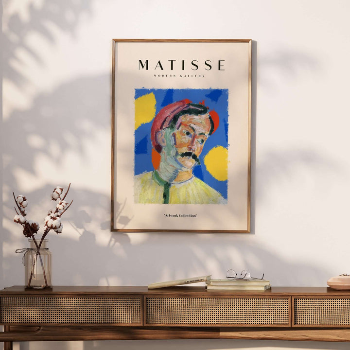Matisse art print featuring an abstract portrait of a man in a red hat against a blue background with yellow shapes.