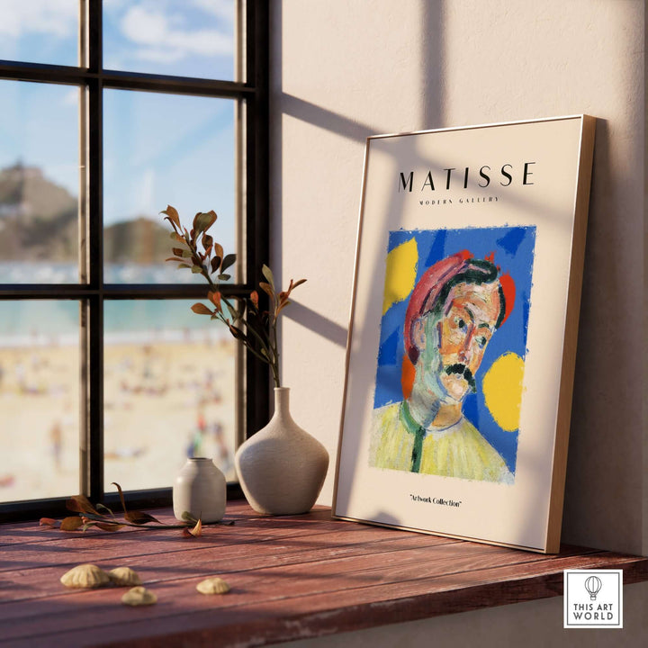 Matisse art print featuring abstract man portrait with vibrant colors, framed beside a window with beach view.