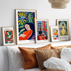 Matisse Art Prints - Abstract Woman in Foliage Poster displayed on a bright sofa with other colorful prints.