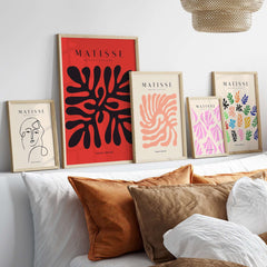 Matisse Art Prints -  Black Abstract Coral Shape Red Poster displayed in a modern living room setting with decorative pillows.