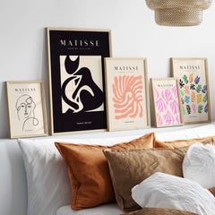 Matisse Art Prints - Black Beige Abstract Composition Poster displayed with other Matisse prints on a modern sofa.