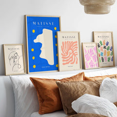 Matisse Art Prints - Blue Abstract Profile with Yellow Dots Poster displayed on a shelf among other art prints.
