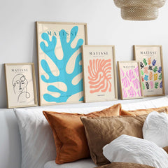 Matisse Art Prints -  Blue Coral Abstract Botanical Art Print Poster displayed on a wall above stylish pillows and decor.