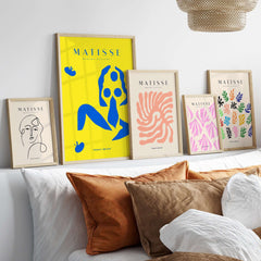 Matisse Art Prints - Blue Nude Abstract Figure Yellow Poster displayed on a stylish wall with various other art prints.