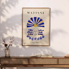 Matisse Art Prints -  Blue & Yellow Abstract Face on a wall with a decorative sunflower headdress and wave patterns.