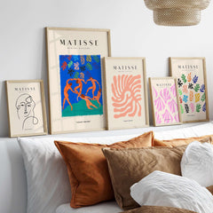 Matisse Art Prints - The Dance Figures Abstract Sky Poster displayed on a wall above decorative pillows.