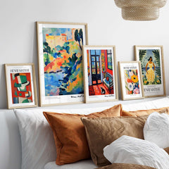 Matisse Art Prints - Woman with Black Cat Interior Poster displayed on a white couch with decorative pillows.