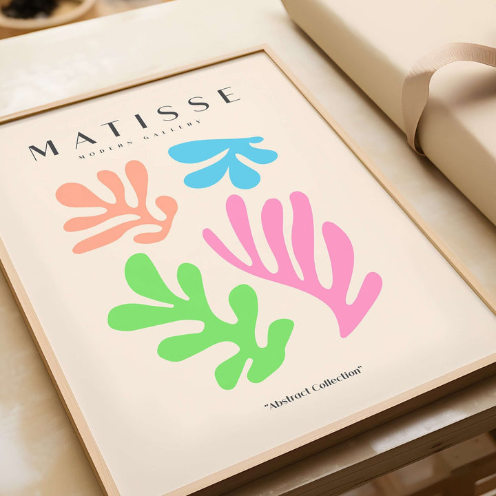Matisse art print featuring colorful abstract cut-outs in pink, green, orange, and blue on a beige background.
