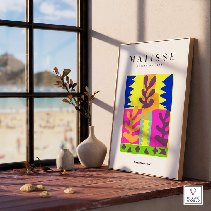 Matisse art print featuring colorful abstract leaves blocks, displayed beside a window with beach view.