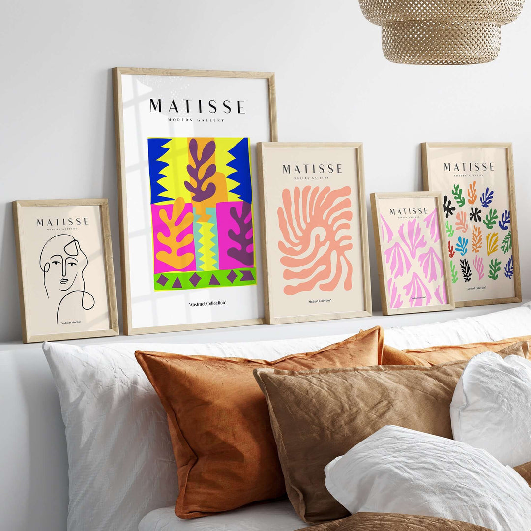 Matisse art prints display on a shelf with colorful abstract leaf designs and modern line art in stylish frames.