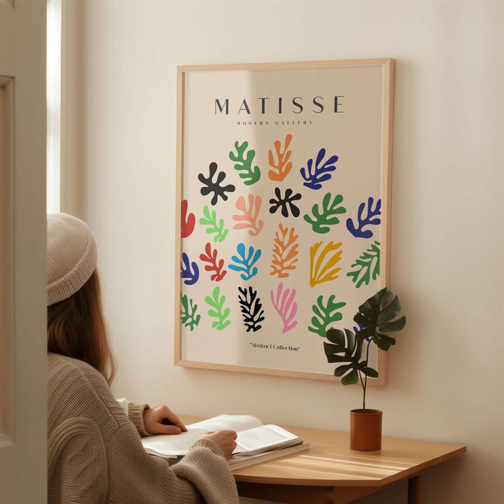 Matisse art print with colorful abstract shapes, displayed in a cozy interior setting.