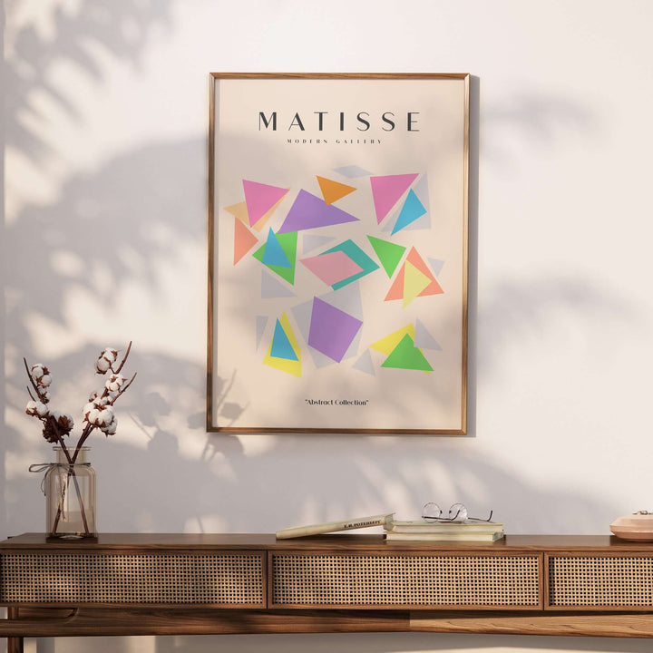 Matisse-inspired poster featuring colorful geometric triangles in purple, pink, green, and blue on a neutral beige background.