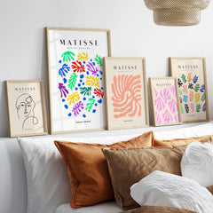 Matisse Art Prints - Colourful Scattered Abstract Leaves Dots Poster displayed in gold frames on a stylish wall.