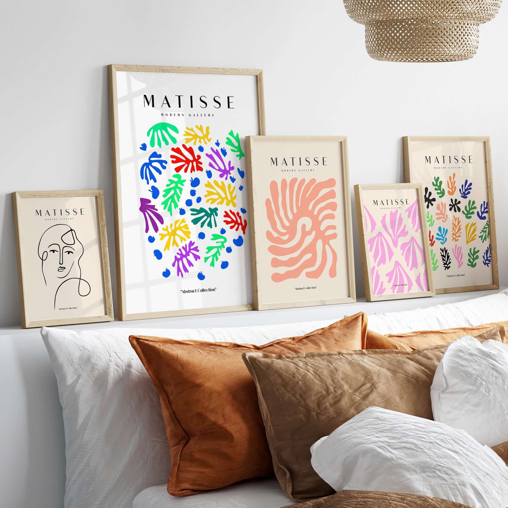 Matisse Art Prints - Colourful Scattered Abstract Leaves Dots Poster displayed in gold frames on a stylish wall.
