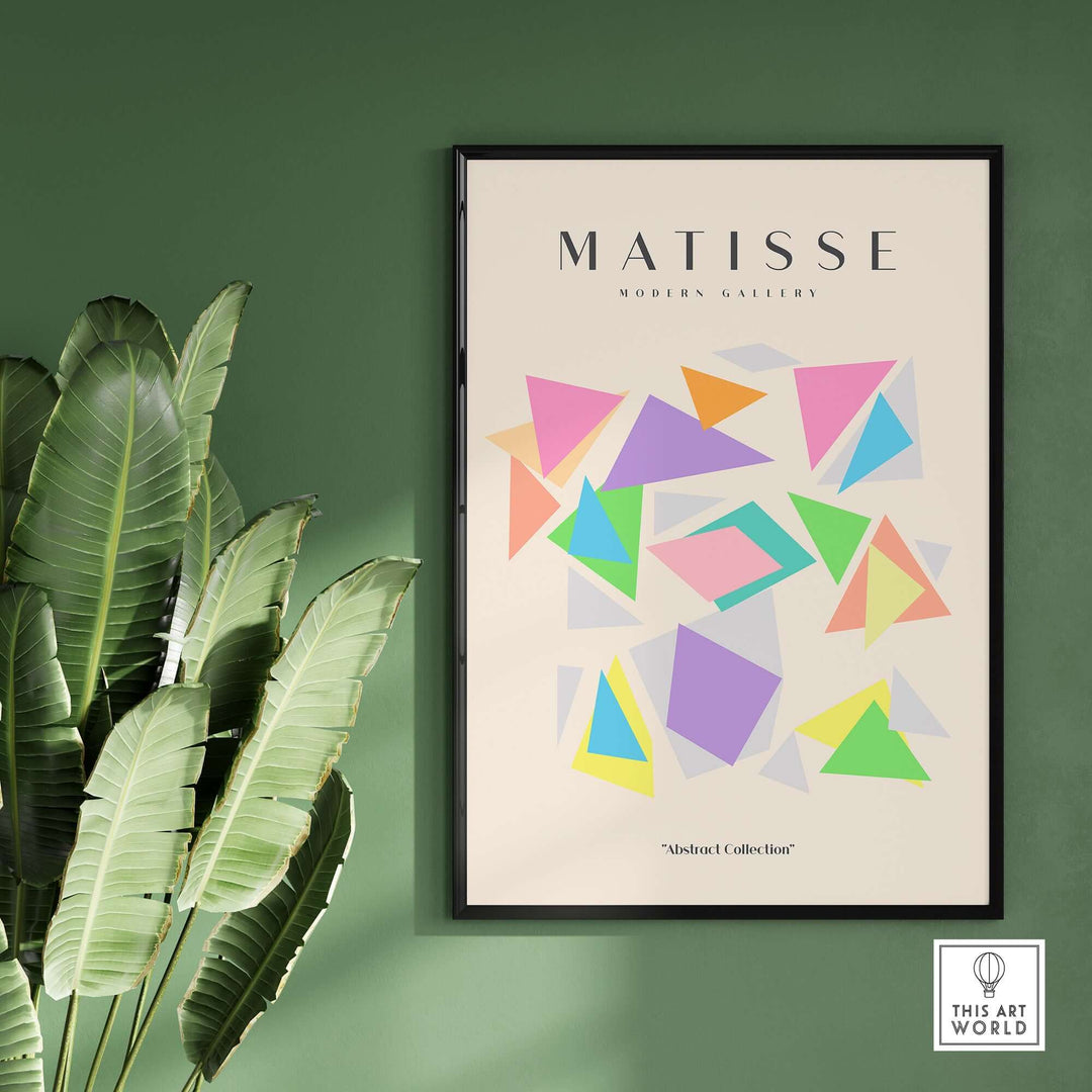 Matisse art print featuring colorful geometric triangles on a beige background, surrounded by lush green leaves.