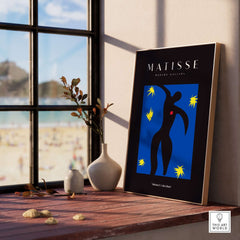 Matisse Art Prints - Icarus Black Figure with Stars Poster displayed in a sunlit room by a window.