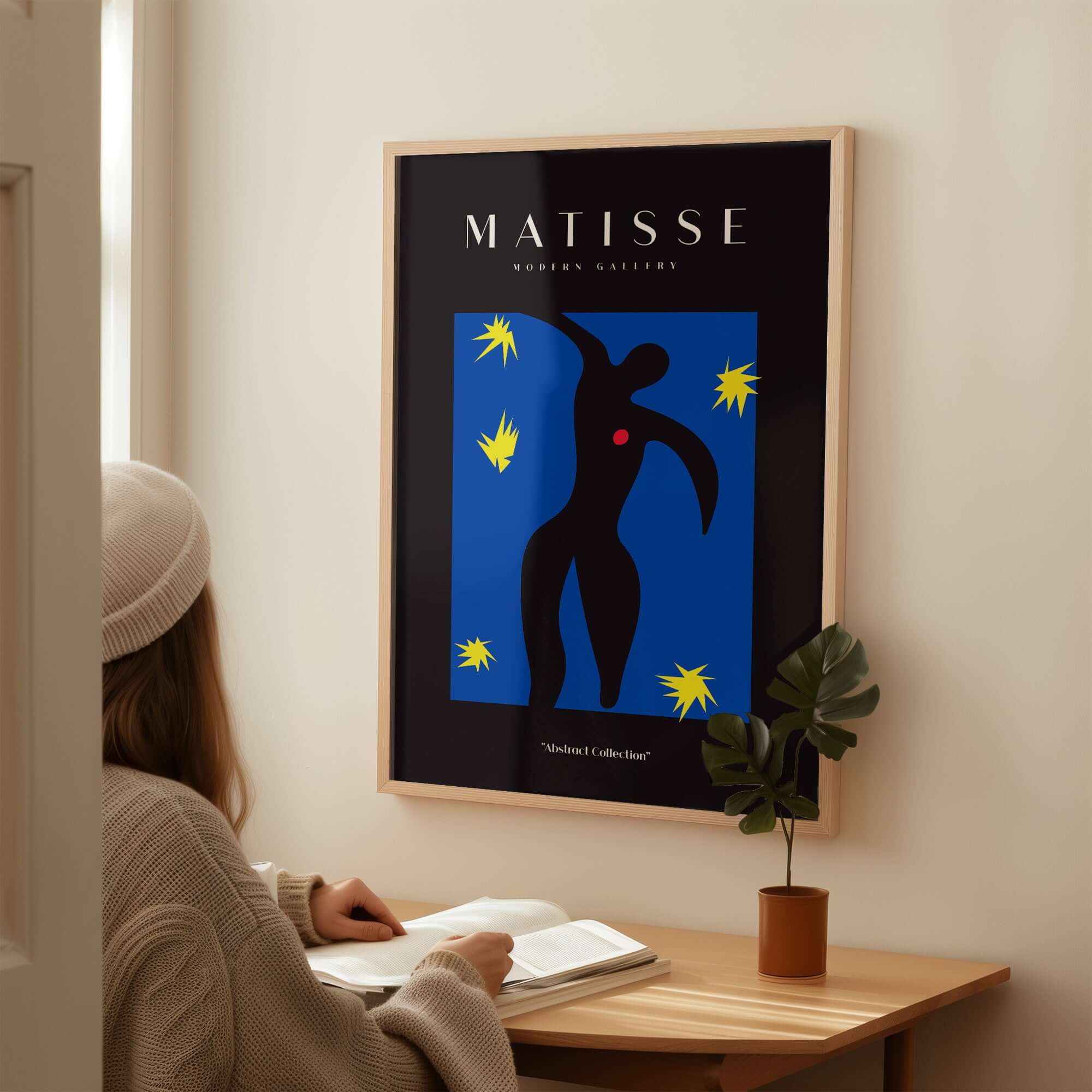 Matisse Art Prints - Icarus Black Figure with Stars Poster displayed in a modern interior with a woman studying.