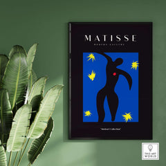 Matisse Art Prints - Icarus Black Figure with Stars Poster displayed on a wall surrounded by lush green plants.