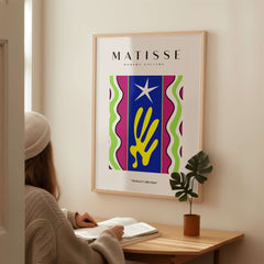 Matisse Art Prints - Jazz Abstract Star Hand Waves Poster displayed in a cozy setting with a woman viewing it.