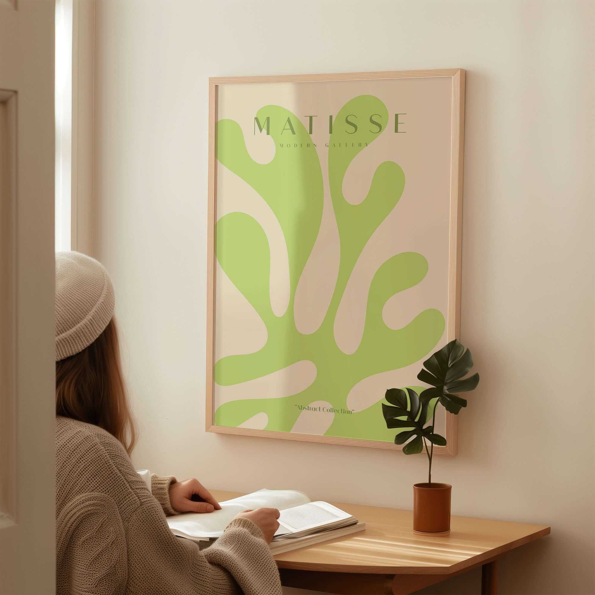 Matisse Art Prints - Lime Green Abstract Coral Shape Poster displayed on a wall with a person studying nearby.