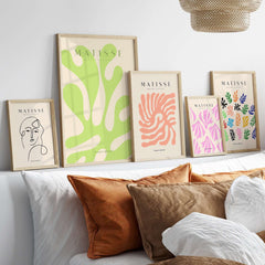 Matisse Art Prints - Lime Green Abstract Coral Shape Poster displayed on a modern gallery wall above a cozy bed.