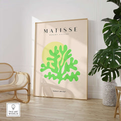 Matisse Art Prints - Lime Green Coral Abstract Sun Print displayed in a modern interior with a plant and chair.