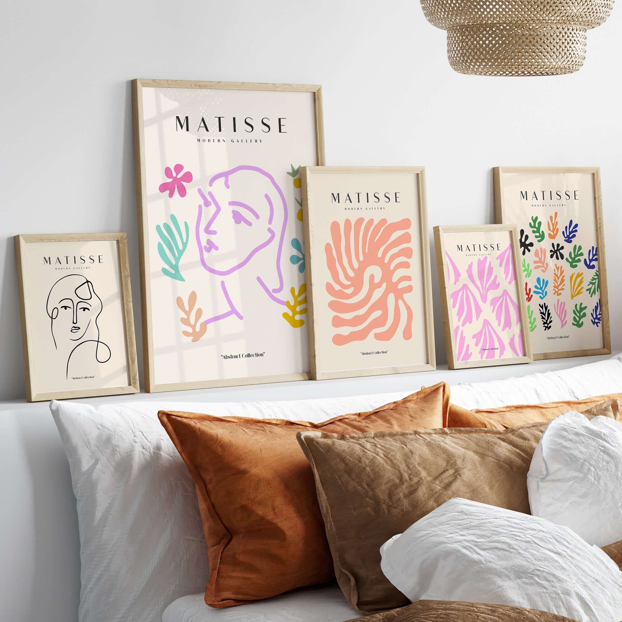 Matisse Art Prints -Line Art Face Abstract Botanical Collage Poster displayed on a wall above a cozy sofa with cushions.