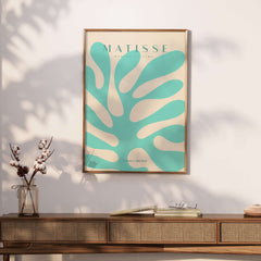 Matisse Art Prints - Mint Green Coral Abstract Seaweed Poster displayed in a modern setting with a wooden table and decor.