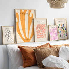 Matisse Art Prints -  Orange Fan Coral Abstract Shape Poster displayed on a wall above a bed with decorative pillows.