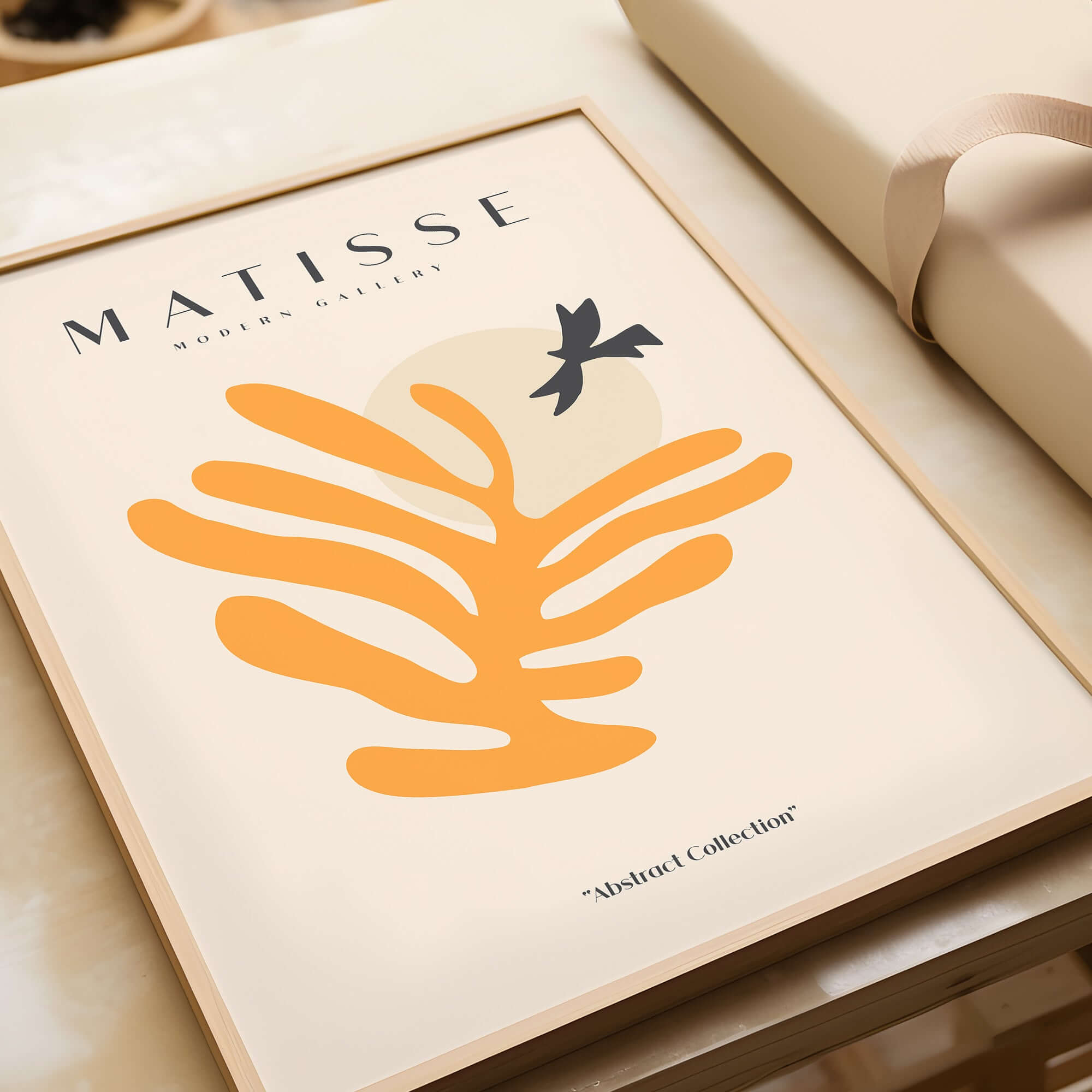 Matisse Art Prints - Orange Leaf Bird Silhouette Poster displayed on a table with soft beige background.