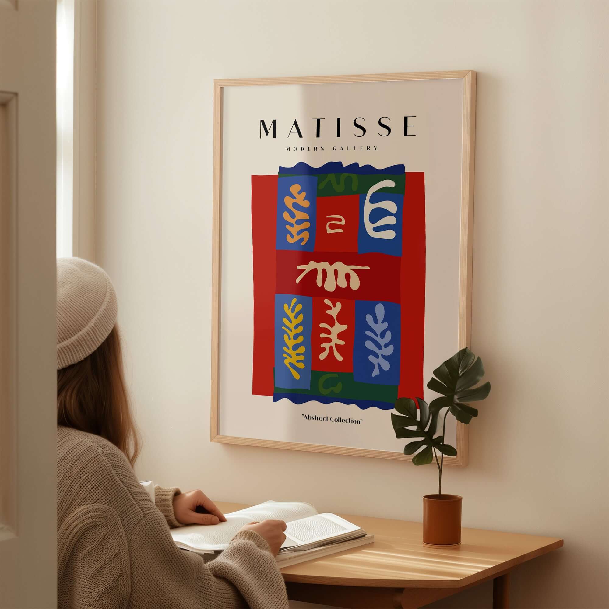 Matisse Art Prints - Patchwork Shapes Composition Poster displayed on a wall with a person studying nearby.