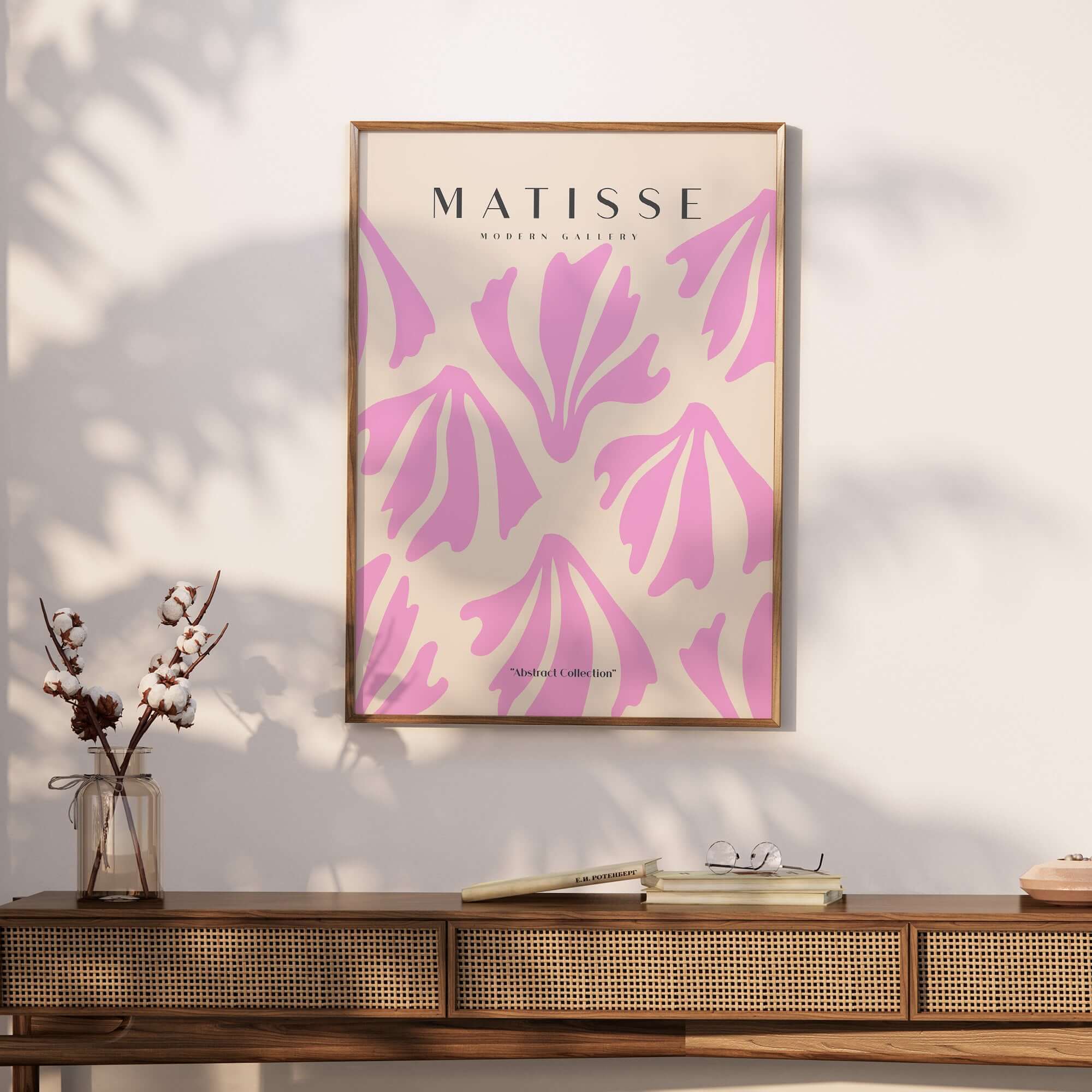 Matisse Art Prints - Pink Abstract Shapes Pattern Poster displayed on a wall above a wooden table with decor.