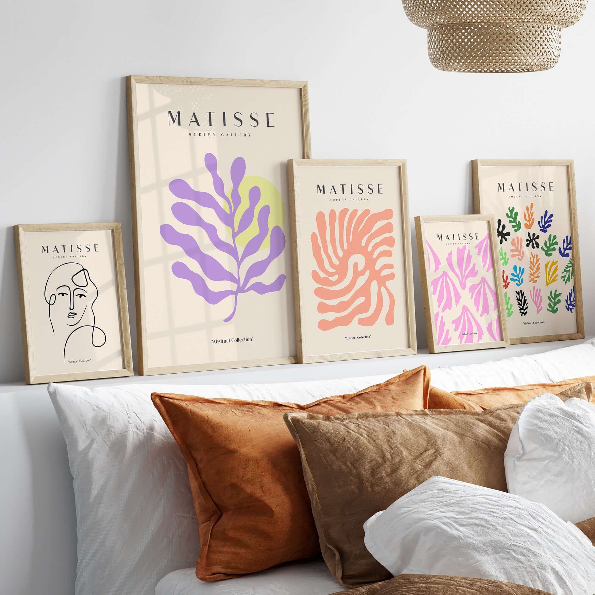 Matisse Art Prints - Purple Botanical Abstract Poster displayed on a wall above a sofa with decorative pillows.