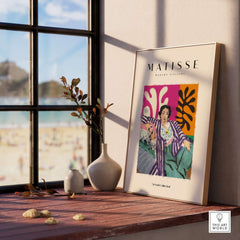 Matisse Art Prints - Reclining Woman Striped Robe Abstract Print displayed on a table by a window with beach view.
