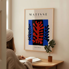 Matisse Art Prints -  Red Coral Black Leaves Blue Frame Poster displayed in a modern decor setting.
