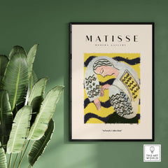 Matisse Art Prints - Resting Woman Patterned Blouse Yellow displayed in modern gallery setting against a green wall.