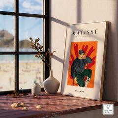 Matisse Art Prints - Seated Figure in Cap Poster displayed on a sunny windowsill with beach view.