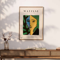 Matisse Art Prints - Split Face Blue Yellow Portrait Poster displayed on a wooden table, showcasing vibrant colors and abstract design.