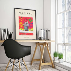 Matisse Art Prints -  Still Life Flowers Lemons Red Pattern Poster framed on wall above a stylish desk.