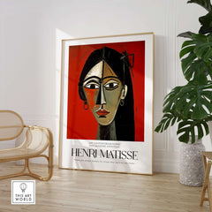 Matisse Art Prints - Stylized Woman Portrait Red Wall Art displayed in a modern interior setting with green plant.
