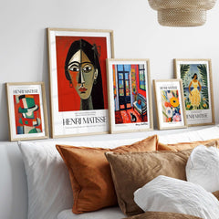 Matisse Art Prints - Stylized Woman Portrait Red Wall Art displayed in a stylish living room setting with other artworks.