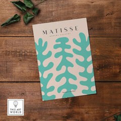 Matisse Art Prints - Teal Coral Pattern Abstract Wall Art showcased on a wooden surface with leaves.