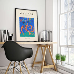 Matisse Art Prints - The Dance Figures Abstract Sky Poster framed on a wall above a modern workspace.