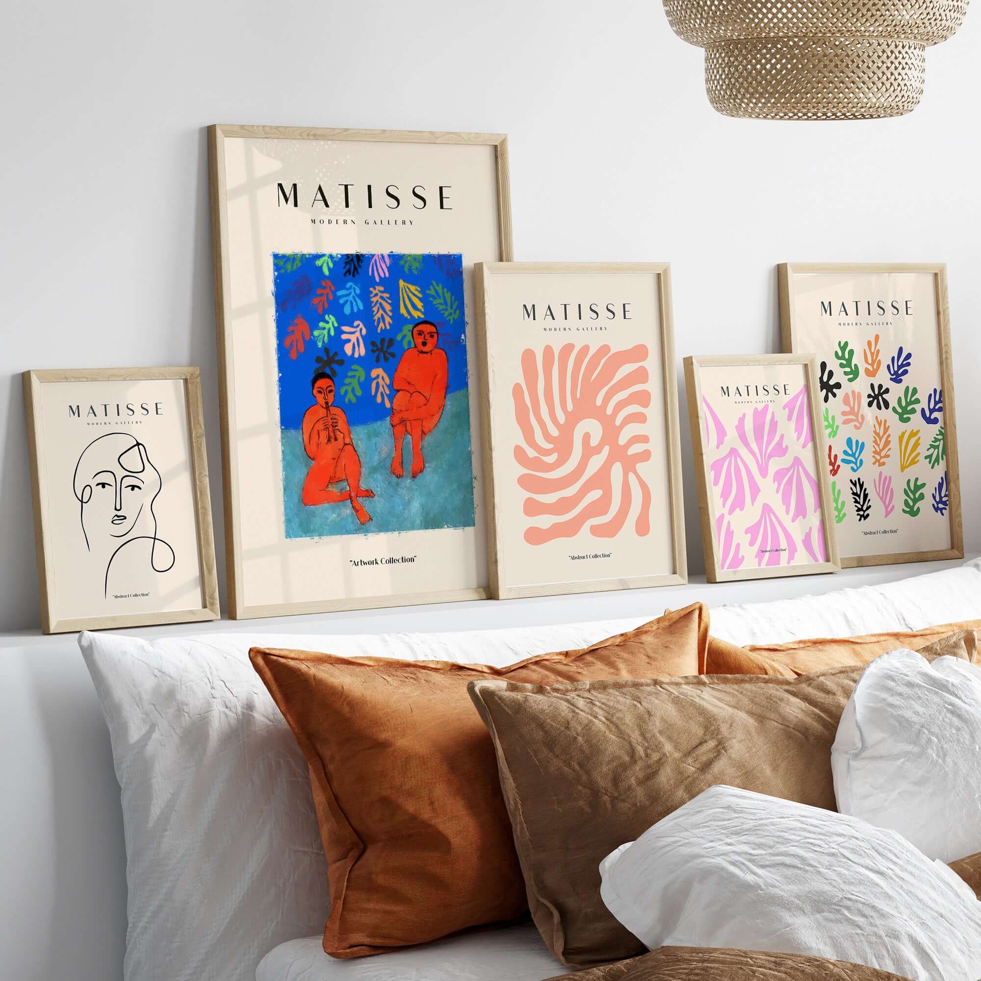 Matisse Art Prints - Two Figures Flute Poster collection displayed above decorative pillows on a cozy sofa.