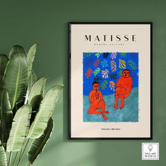 Matisse Art Prints - Two Figures Flute Poster displayed in modern gallery setting with green wall and large leaves.