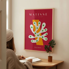 Matisse Art Prints - White Coral Abstract Green Diamonds Print showcased on a wall with a woman observing in a cozy setting.